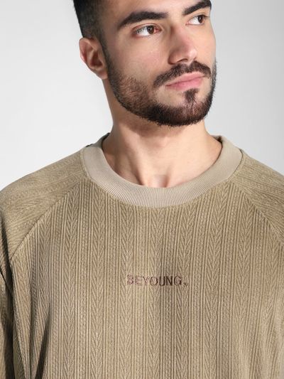 Man wearing a beige textured sweatshirt for men