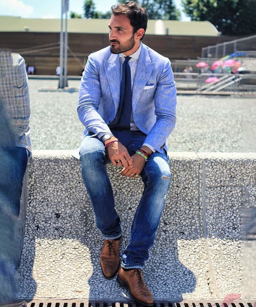 Portrait of Business Man Wearing blue blazer black pants short haircut  ear stud bracelets finger ring a young black guy standing against metal  Stock Photo  Alamy