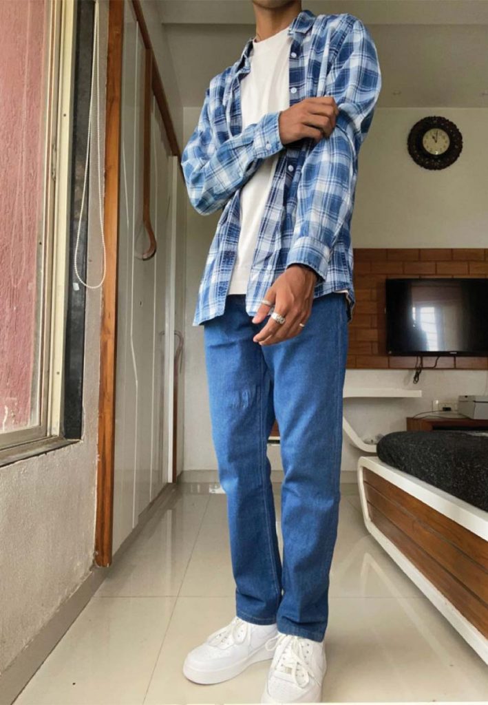 Indian Male Model In Purple Check Shirt And Blue Jeans Stock Photo